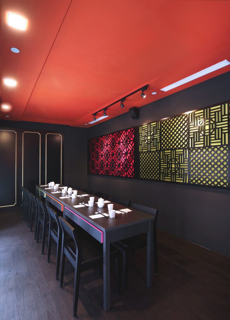Isshi Ramen restaurant interior design counter seating with red wall